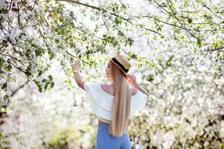 vintage style. romantic mood .girl enjoys the beauty of a flowering garden. backの写真素材