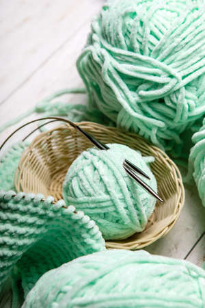 Knitting project in progress.piece of knitting with ball of yarn and a knitting needles.の写真素材