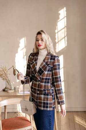 Smiling busy girl standing in home officeの写真素材