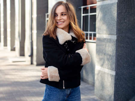 Amazing joyful pretty girl with long brunette hair. posing outdoor. fashion street stile portrait Model smile looking aside.の写真素材