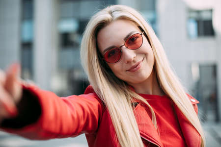 Close up portrait Nice laughing girl , making selfie.beautiful blonde with long hair and charmingly...