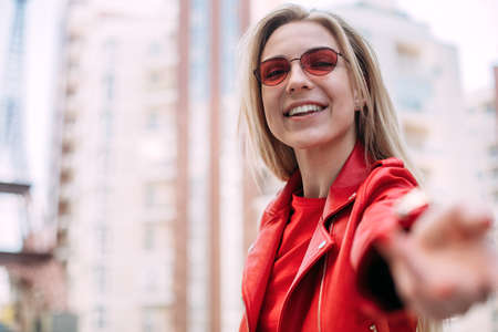 Close up portrait Nice laughing girl , making selfie.Outdoor portrait of cute blonde lady wears...