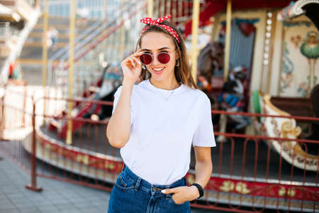 Beautiful blonde woman wearing sunglasses close-up portrait of a young sexy girl hipster in the park...