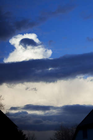 Thunderstorms and rough clouds in a blue skyの写真素材