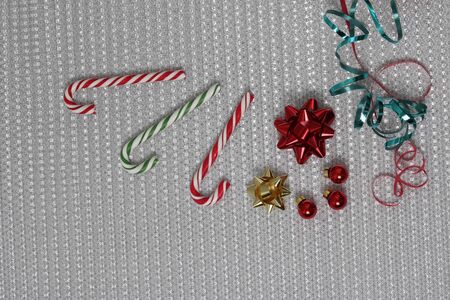 decorations on a shiny background. ribbons, gift bows and sweet caramel stickの写真素材