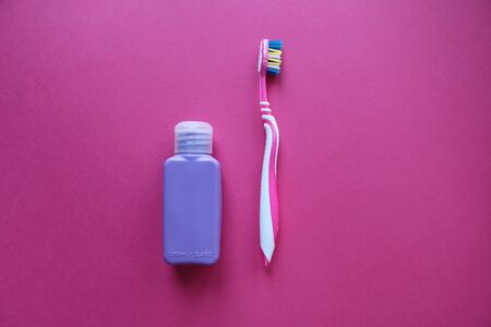 Top view of a pink toothbrush and purple jar.Taking care of teeth, dental concept. Flat lay photo.の写真素材