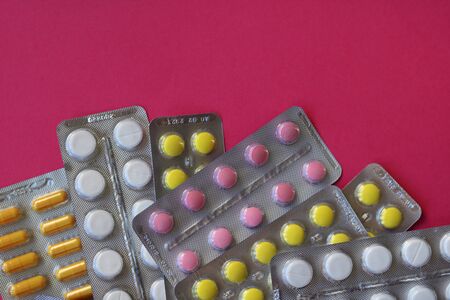 Pharmaceutical blister pack. Pack of pills with tablets. Pink background.