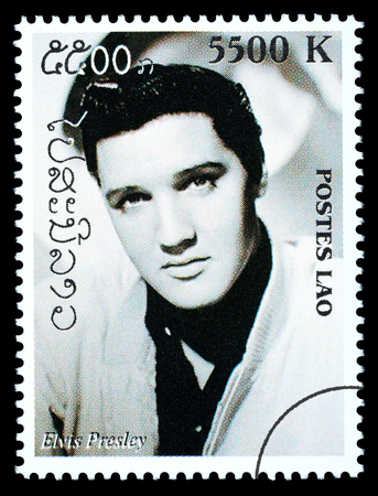 LAOS - CIRCA 1999: A postage stamp printed in Laos showing Elvis Presley, circa 1999のeditorial素材