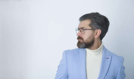 Side view portrait of serious fashionable handsome man in blue suit.の写真素材