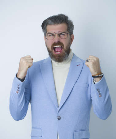 Handsome nifty man happy in stylish bright blue suit posing at studio.
