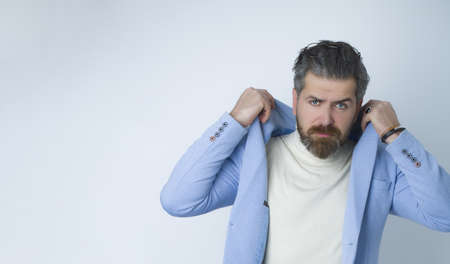 Portrait of serious handsome man in blue suit.