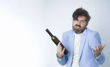 Young man drunk with a bottle of wine.の写真素材