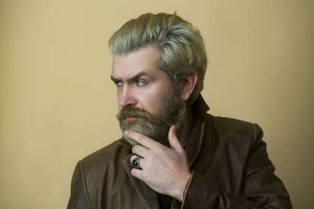 Dramatic fashion model thinking in leather jacket.