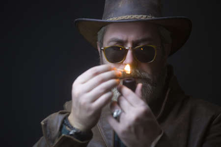 Handsome moustache and beard hipster man smoking pipe.の写真素材