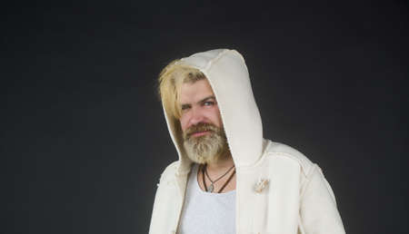 Handsome confident mature man with beard stands dark background for your text message or...