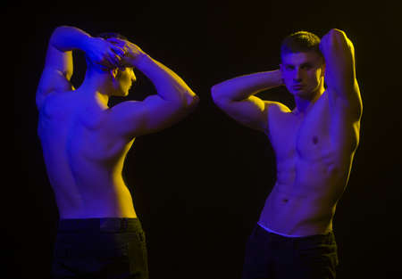 Two young men with sexy body showing their muscular torso and abs.