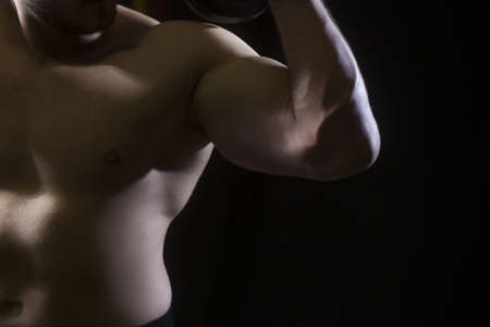 An image of a muscular man flexing his biceps.の写真素材