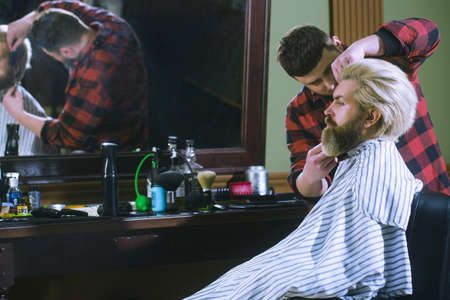 Barbershop. The client in the master s chair in the barbershop.