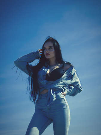 Fashion model in jeans clothing. Summer park outdoor.