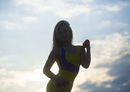 Freedom happy relax lifestyle healthcare concept. Pretty girl with dumbbells on the sky.