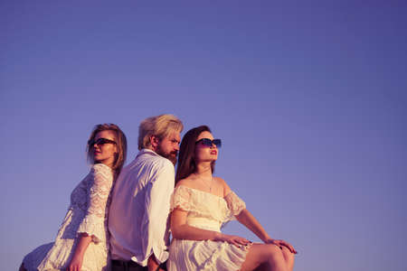 Group of people having fun outdoors, summer sunset.の写真素材