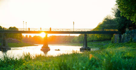 View of bridge on river Uzh at city Uzhgorod, Transcarpathia, Ukraine Europe. Amazing sunset time.の写真素材
