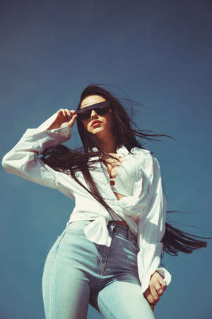Portrait confident successful beautiful attractive brunette young woman fashion girl model posing with sunglasses.の写真素材