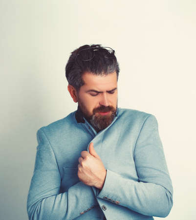 Bearded man in suit shivering from cold isolated on white.の写真素材