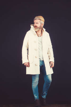 Elegant handsome man in stylish coat. Full length portrait of a young fashion male.の写真素材