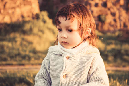 Portrait of brunette little boy posing outside.の写真素材