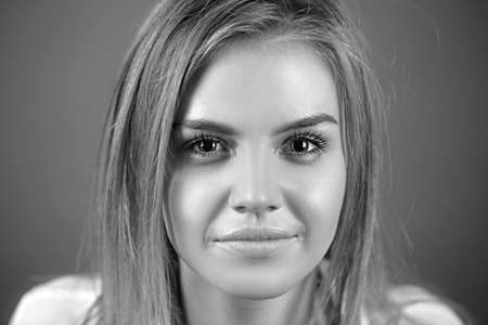 Woman face young beautiful healthy skin portrait. Calm female with bright hair looking at camera...