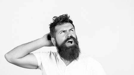 Carefree joyful handsome bearded man having shining eyes opening his mouth with joy bursting into laughing. Headshot of surprised young man keeping mouth open.の写真素材