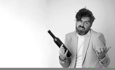 Young man drunk with a bottle of wine.