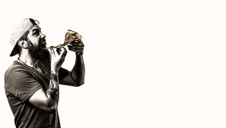 Handsome young man with slice of delicious pizza.の写真素材