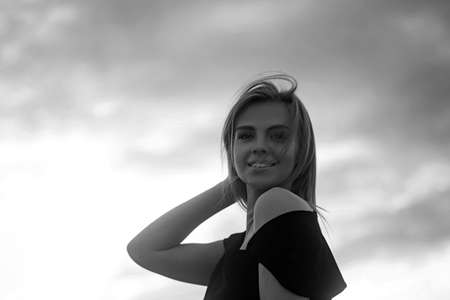Amazing blond with perfect smile looks unforgettable in her black dress.