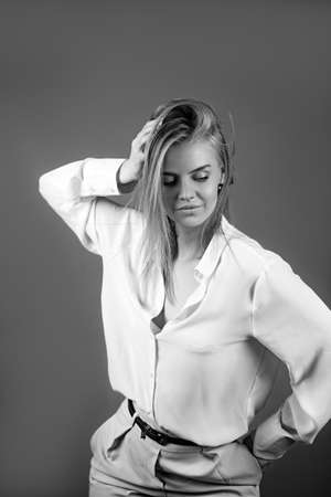 Colorful studio portrait of hipster fashion smiling girl with hands on hips at red background.の写真素材