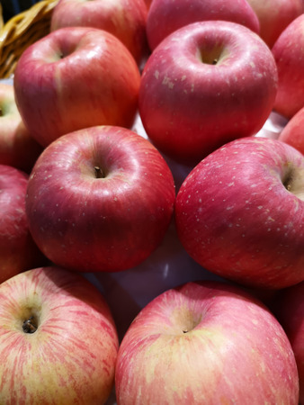 The fresh red apples are sold on shelves in supermarkets.の写真素材