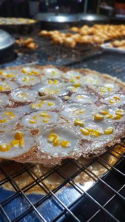 Mortar-toasted pastry with corn on the tray at the shop in the market,street food.の写真素材
