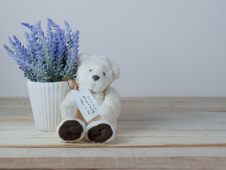 Purple lavender pots and cute teddy bears with greeting cards on Mother's Day and placed on a wooden table for the backgroundの写真素材