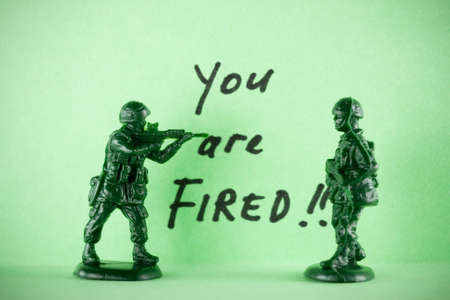 Toy soldiers being shoot by gunman. - concept of Youre fired!の写真素材