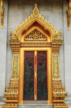 wood door carves in a temple of Thailandの写真素材