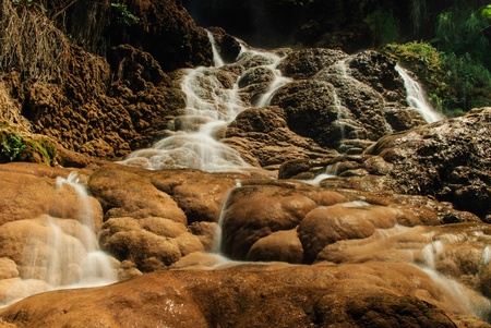 The waterfall and the stone and the tourist attraction of Thailandの写真素材