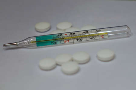 The thermometer shows the temperature of 36 6 and tabletsの写真素材