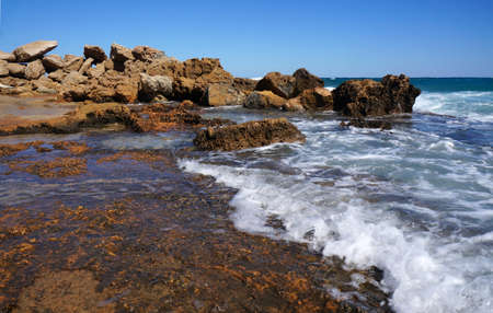 Huge rocks on the coast of the storm sea                               の写真素材