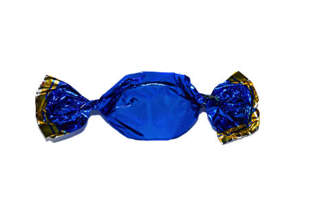   Candy in a dark blue shiny paper wrapper closeup                             の写真素材