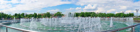 Panorama beautiful fountain against the blue sky with cloudsの写真素材