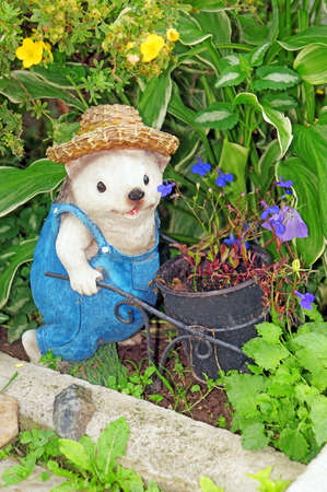 Figure of a hedgehog-gardener with hat and with trolleyの写真素材