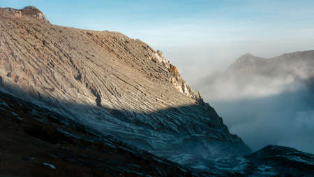 Toxic volcano Ijen on Java island, Indonesia. Foggy sunrise, another planet landscape.の写真素材