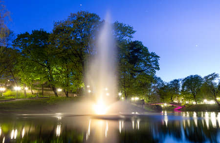 Night illuminated fountain at city canal in Riga, Latvia, long exposureの写真素材