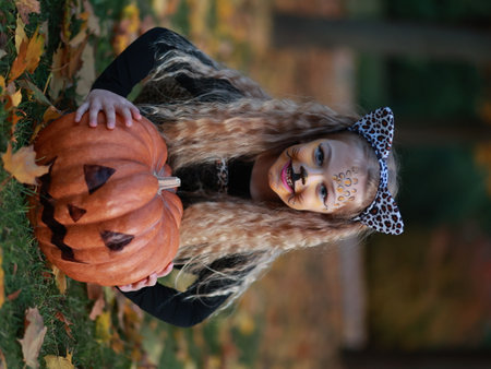 Little girl celebrates Halloween in the parkの写真素材